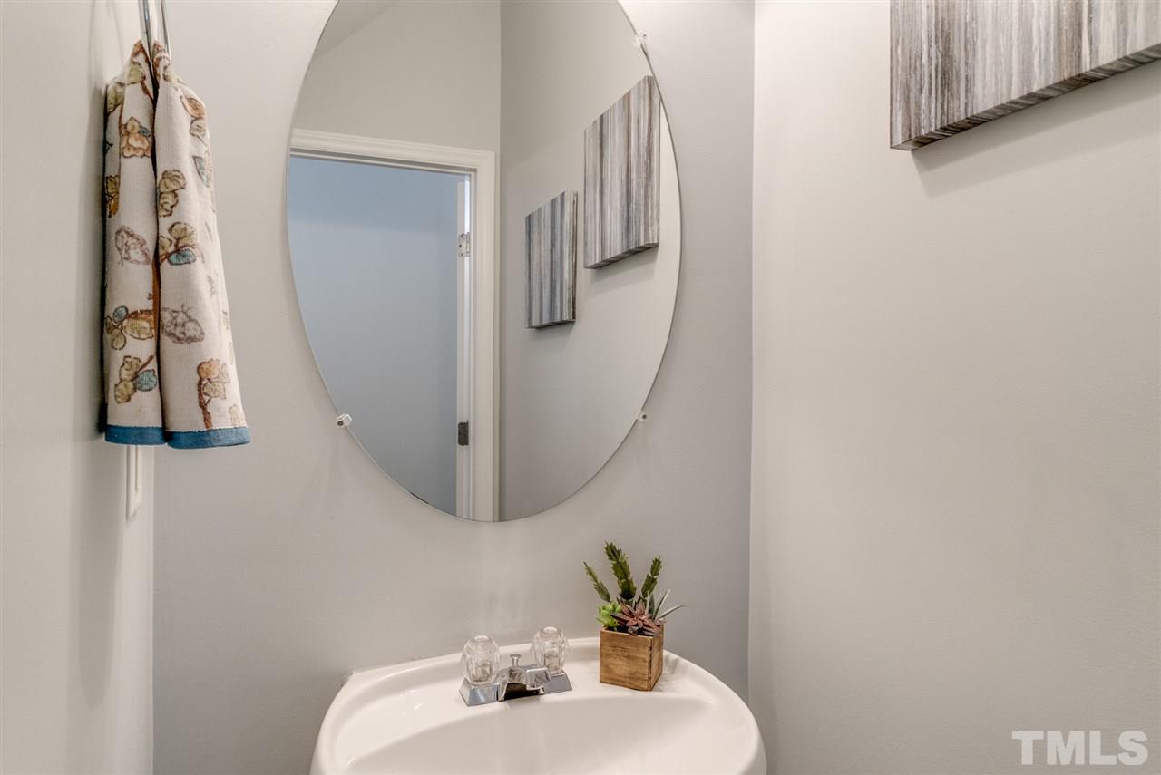 8404 Whisper Ridge Place Raleigh, NC 27613 - Photo 10 of 25 a bathroom with a sink and a mirror