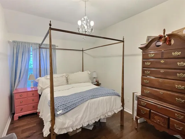 a bedroom with a bed and a chandelier