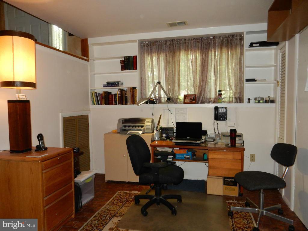 105 Haverhill Road Joppa, MD 21085 - Photo 14 of 21 a view of a workspace with furniture and a fireplace