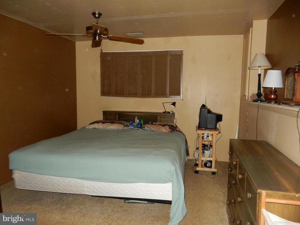 105 Haverhill Road Joppa, MD 21085 - Photo 6 of 21 a bedroom with a bed and a flat tv screen on the dresser