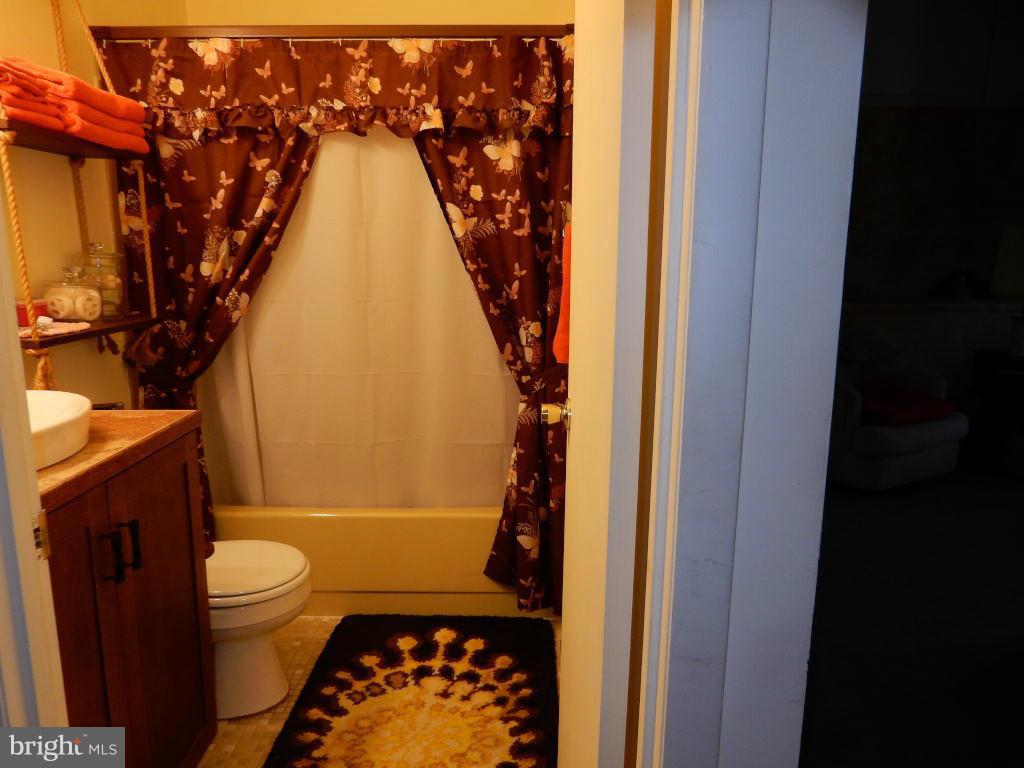 105 Haverhill Road Joppa, MD 21085 - Photo 9 of 21 a bathroom with a toilet and a shower curtain