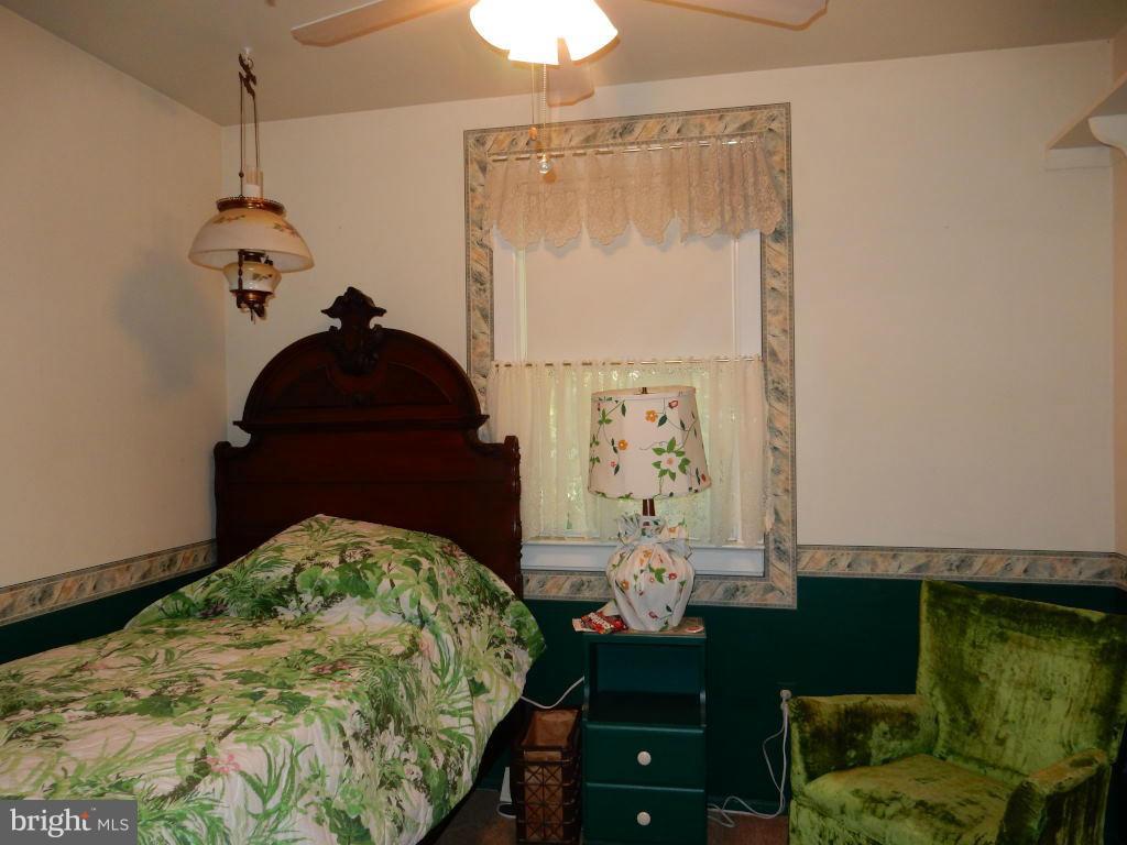 105 Haverhill Road Joppa, MD 21085 - Photo 10 of 21 a bed room with a bed and a chandelier