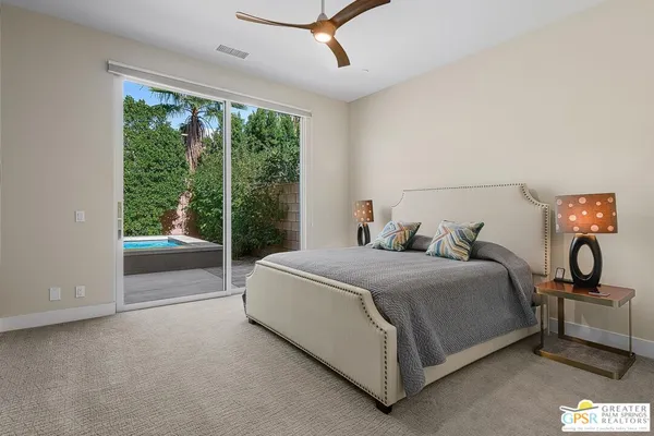 a bedroom with a bed and a refrigerator