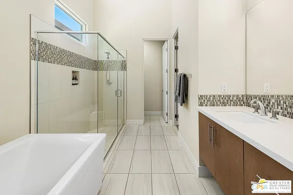 a bathroom with a sink mirror toilet and shower
