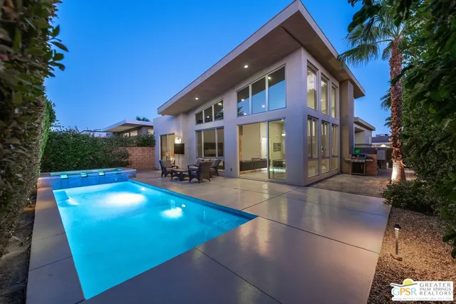 a view of a tennis ground with large trees