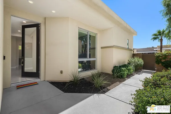 a kitchen with stainless steel appliances granite countertop a stove and a view of living room