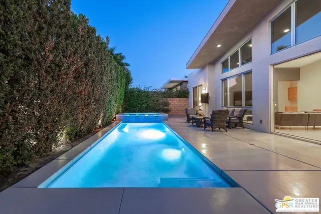 a backyard of a house with table and chairs