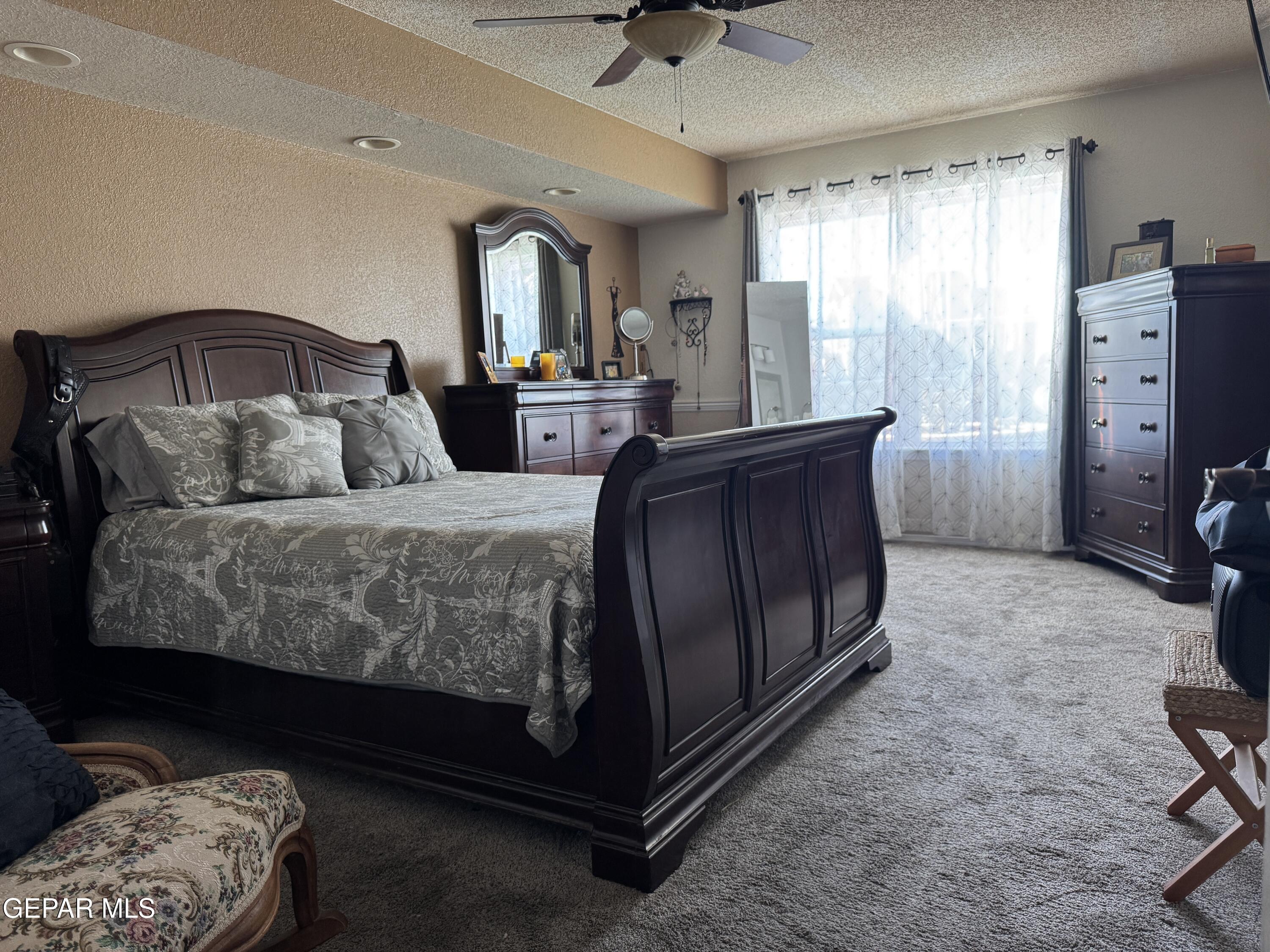 4621 Esparza Lane El Paso, TX 79934 - Photo 13 of 24 a bedroom with a bed and a dresser in it