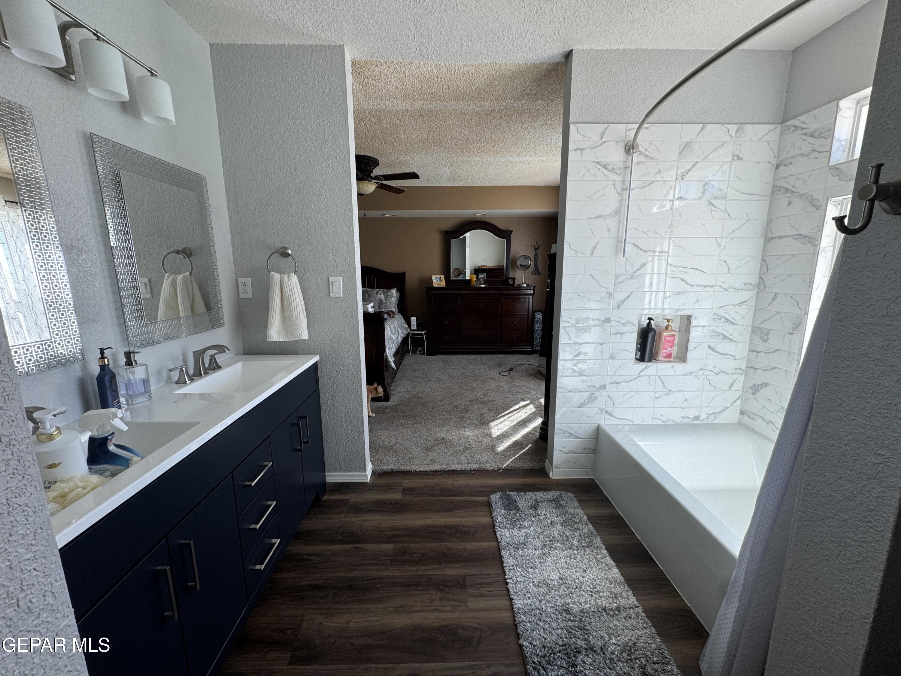 4621 Esparza Lane El Paso, TX 79934 - Photo 14 of 24 a bathroom with a tub sink and mirror