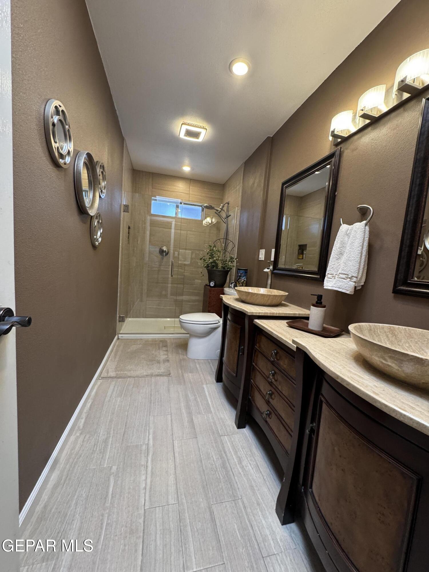 4621 Esparza Lane El Paso, TX 79934 - Photo 17 of 24 a bathroom with a sink and a mirror