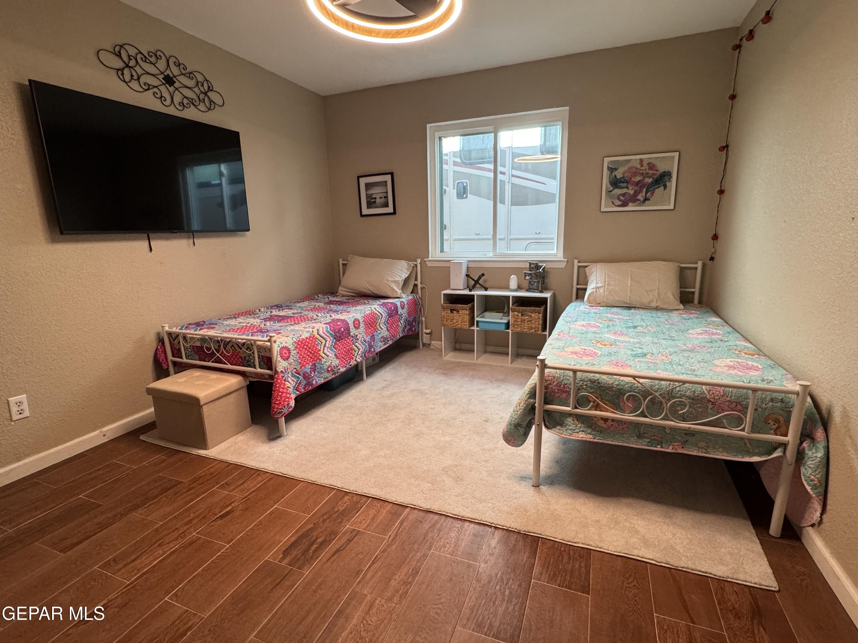 4621 Esparza Lane El Paso, TX 79934 - Photo 18 of 24 a bedroom with a bed and a flat screen tv