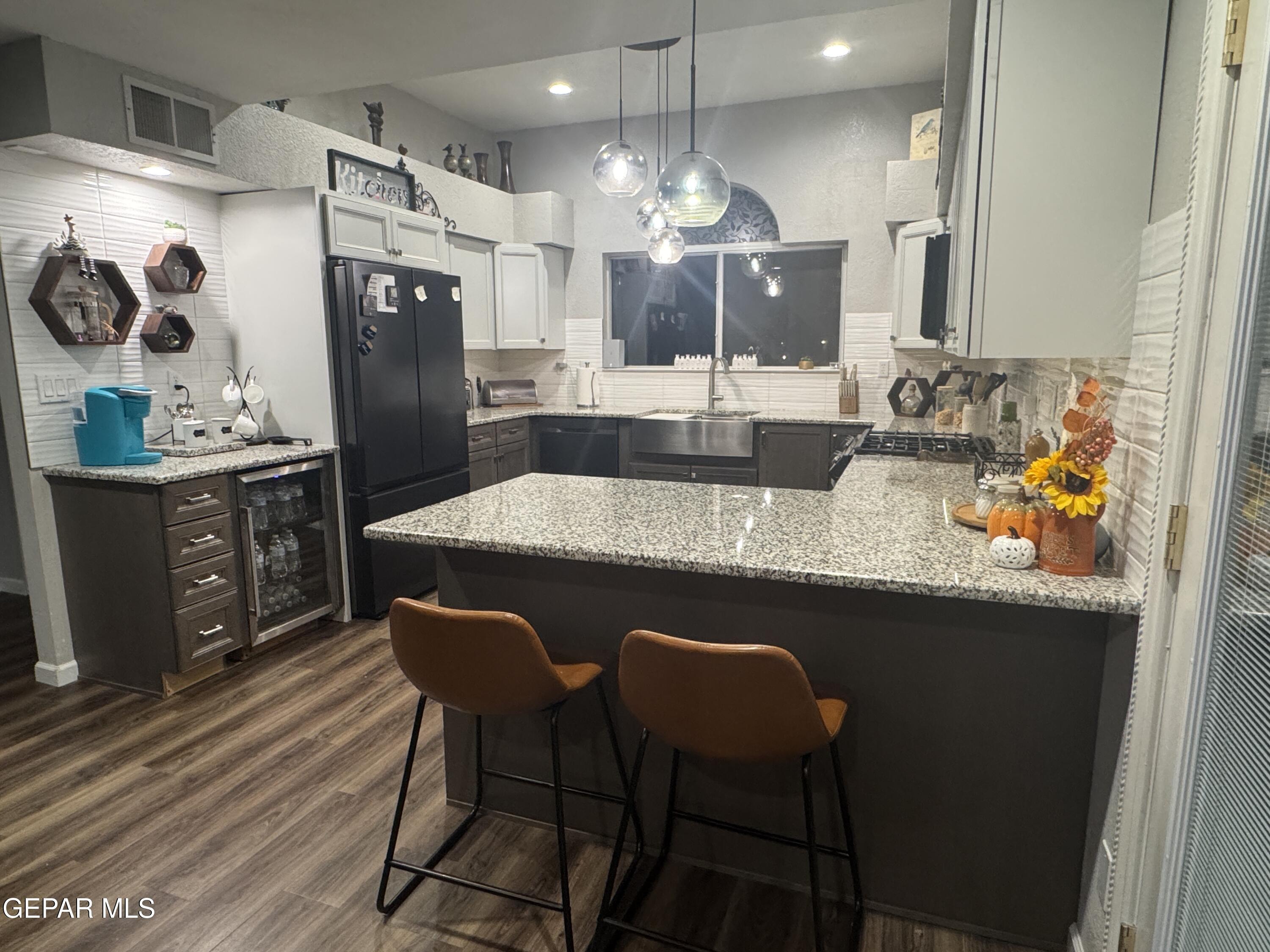 4621 Esparza Lane El Paso, TX 79934 - Photo 7 of 24 a kitchen with granite countertop a sink cabinets and stainless steel appliances