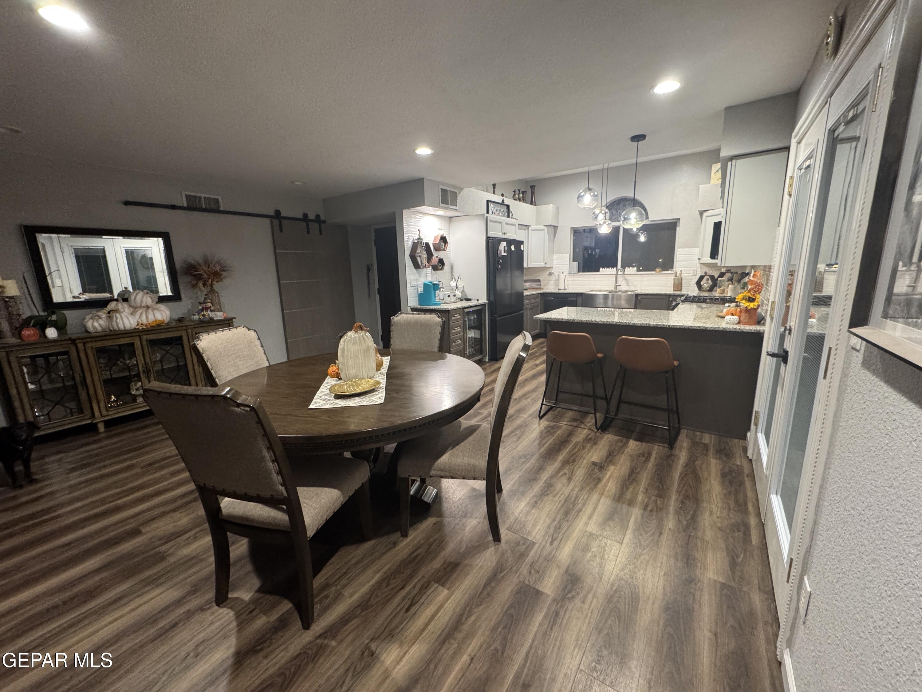 4621 Esparza Lane El Paso, TX 79934 - Photo 10 of 24 a kitchen with a dining table chairs and refrigerator