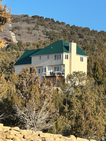 12645 East Cedar Ridge Drive Fairview, UT 84629 - Photo 25 of 25 Back of house with a chimney, a metal roof, and a balcony