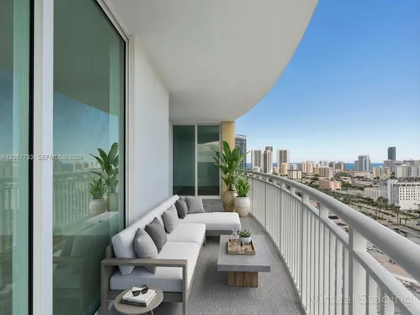 a balcony with furniture and a potted plant