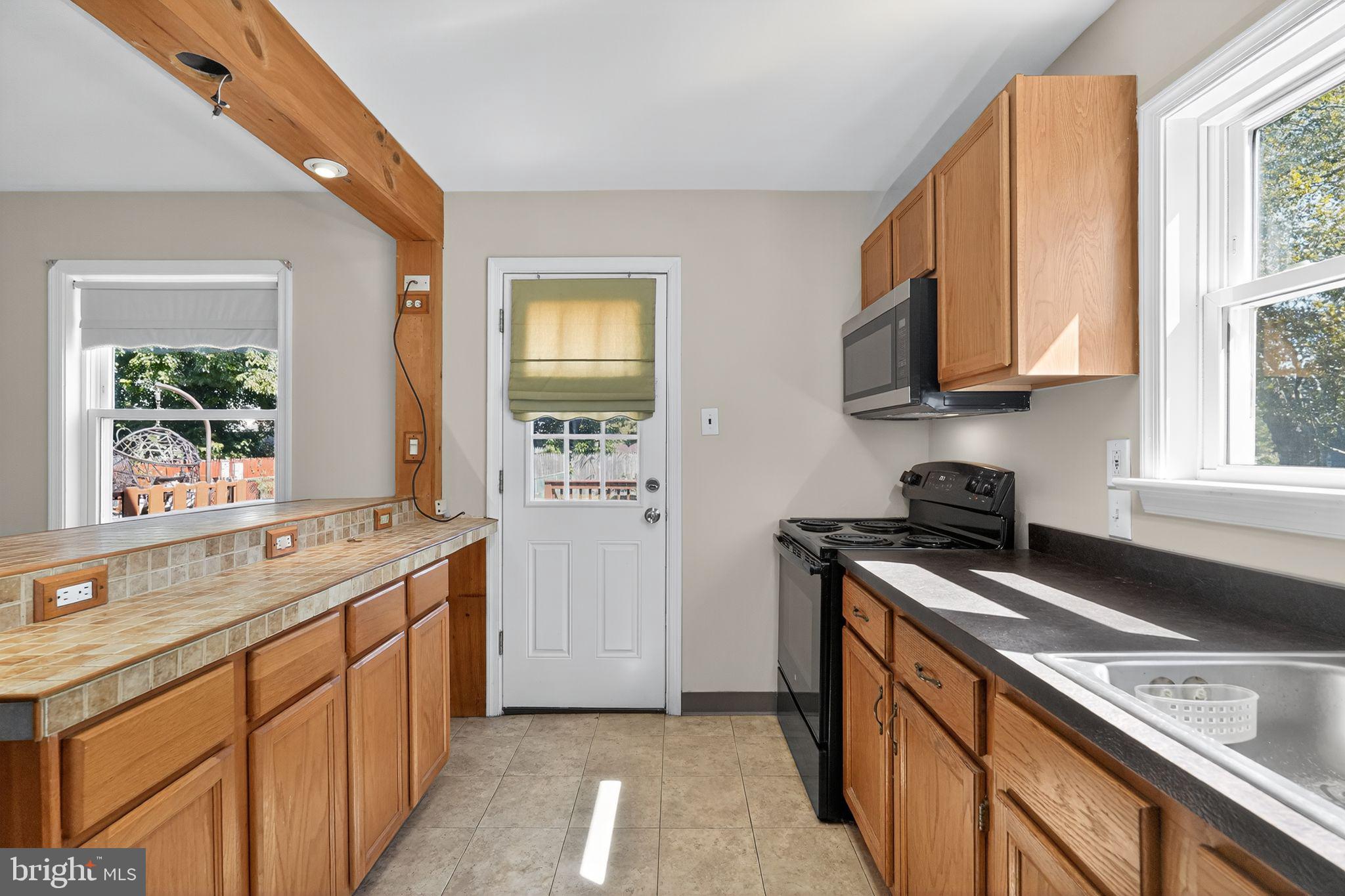 533 Crotzer Avenue Folcroft, PA 19032 - Photo 13 of 30 a kitchen with a sink stove top oven and cabinets