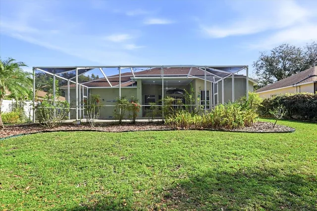 a view of a house with backyard and porch