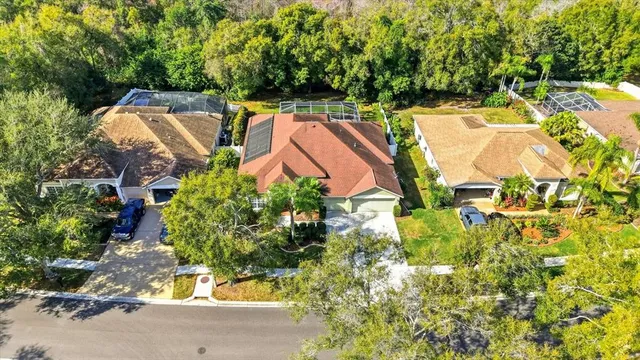 an aerial view of a house with yard swimming pool and outdoor seating