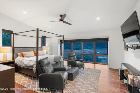 a bedroom with furniture and a flat screen tv