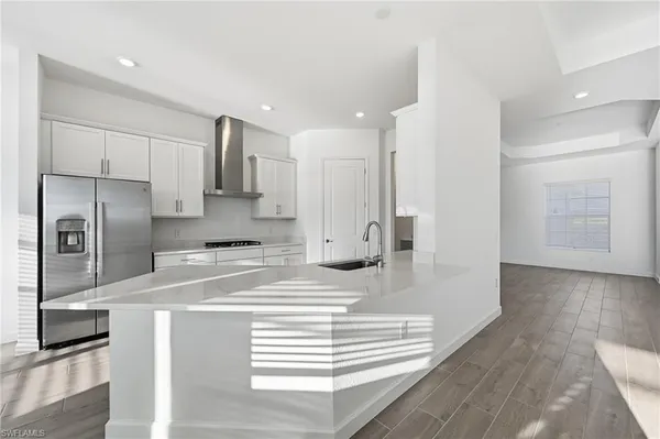 a kitchen with stainless steel appliances a refrigerator and a stove