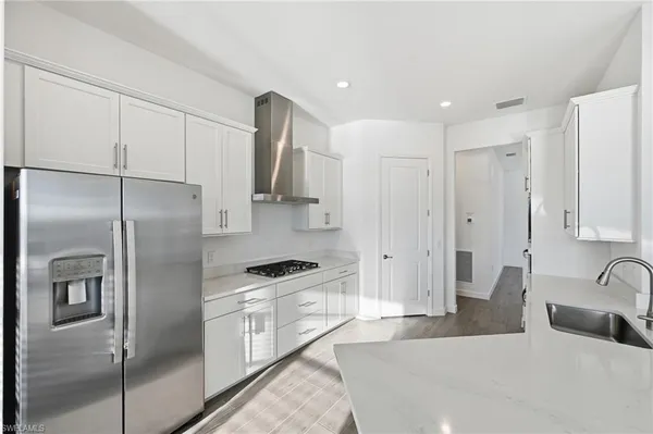 a kitchen with stainless steel appliances a refrigerator sink and cabinets