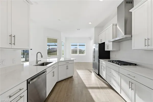 a kitchen with a sink stove and cabinets