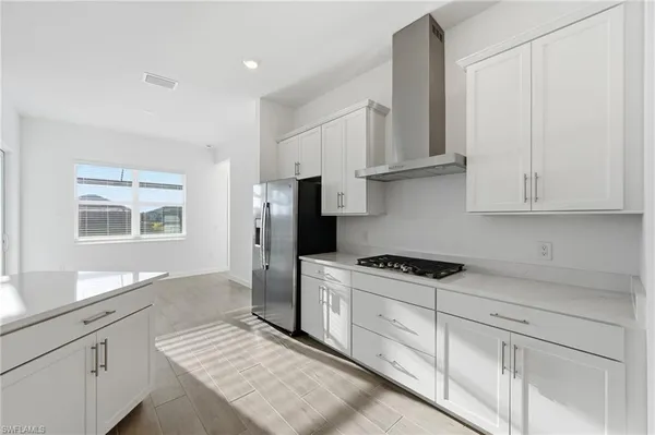 a kitchen with stainless steel appliances granite countertop a refrigerator sink and cabinets