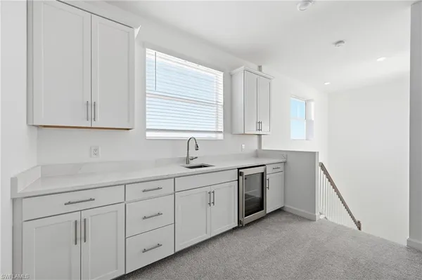 a kitchen with a sink cabinets and window