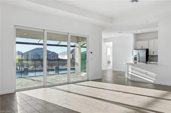 a living room with hardwood floor and glass door