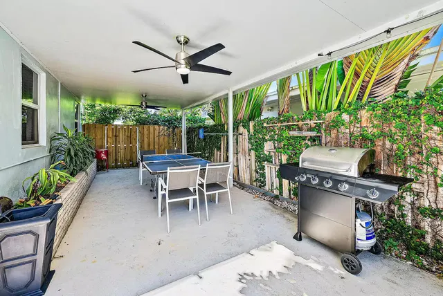 a living room with stainless steel appliances furniture a dining table and chairs in it