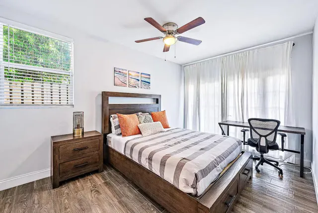 a view of a livingroom with workspace and a window