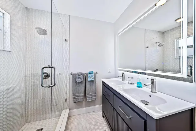 a white toilet sitting next to a bathroom sink