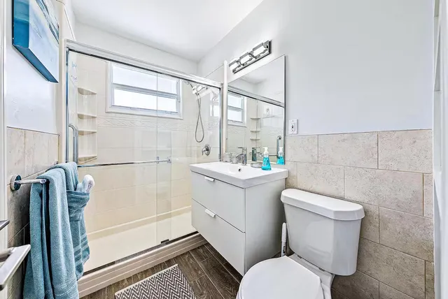 a bedroom with a bed and a ceiling fan