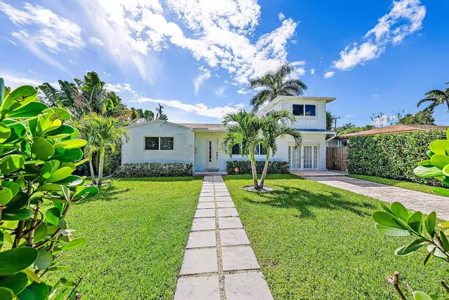a front view of a house with a yard table and chairs