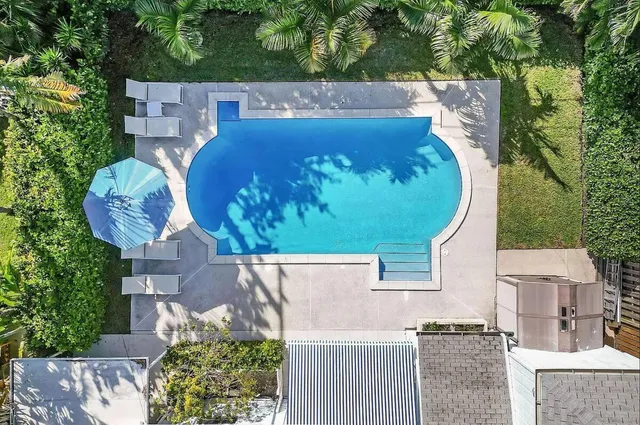 an aerial view of a house with a swimming pool
