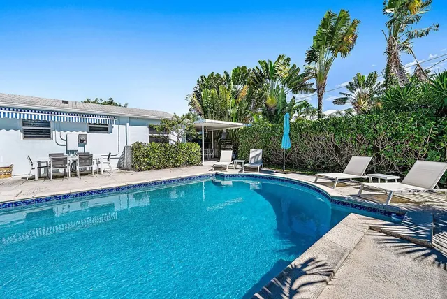 a view of a swimming pool with a lounge chairs
