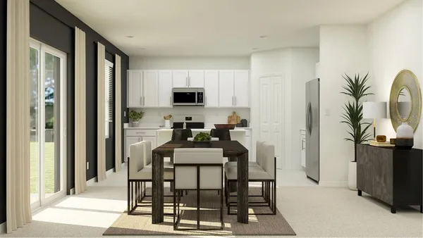 a dining room with furniture and kitchen view