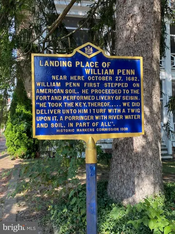 a view of a red door and an tree