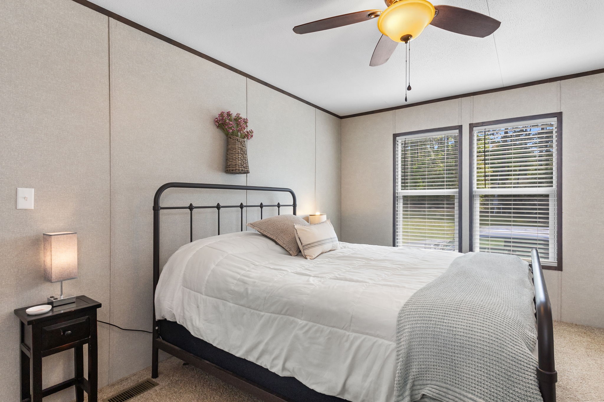 275 Bryan Street Zavalla, TX 75980 - Photo 16 of 24 a bedroom with a bed and a chandelier