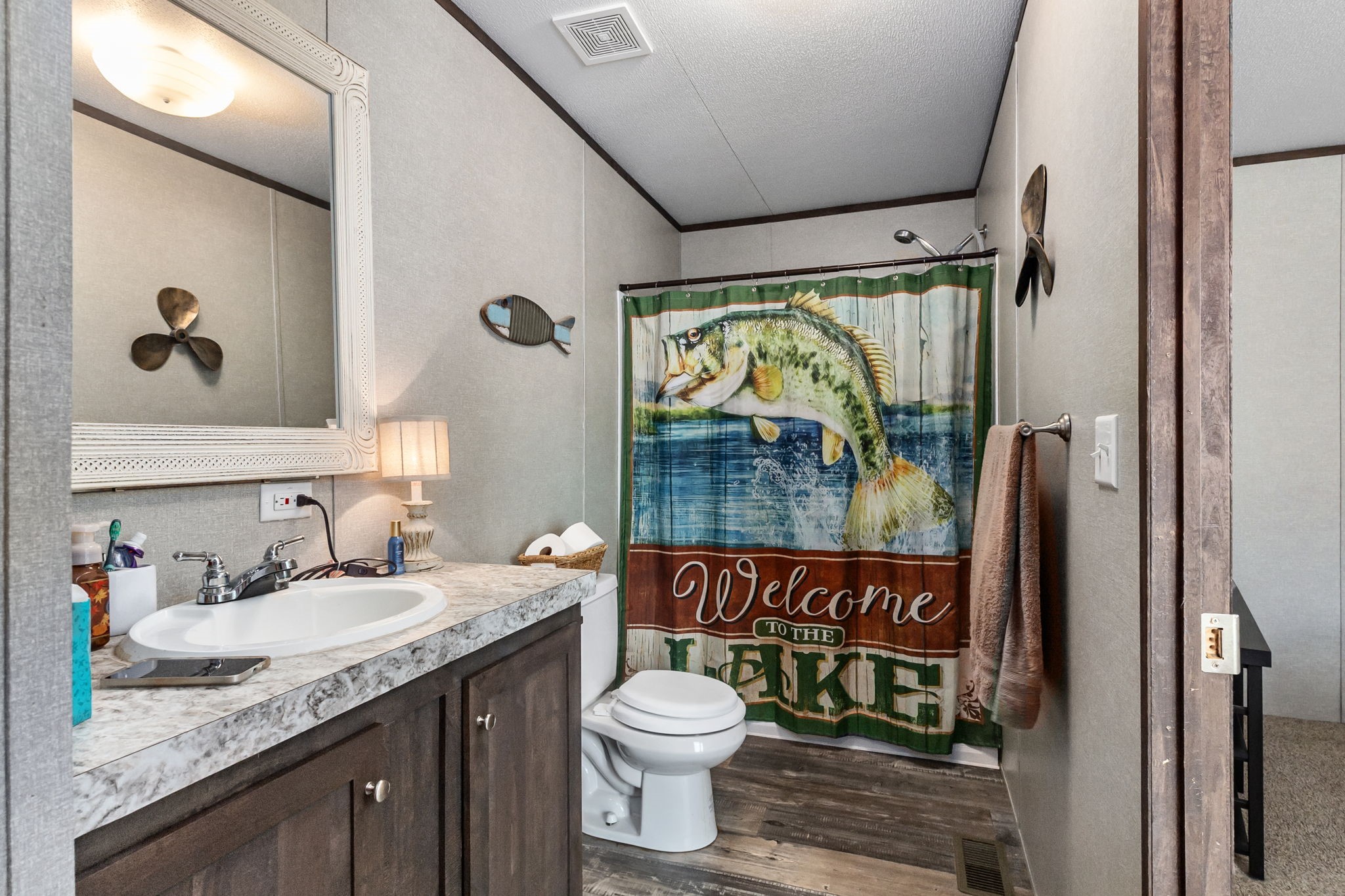 275 Bryan Street Zavalla, TX 75980 - Photo 18 of 24 a bathroom with a granite countertop sink toilet and shower