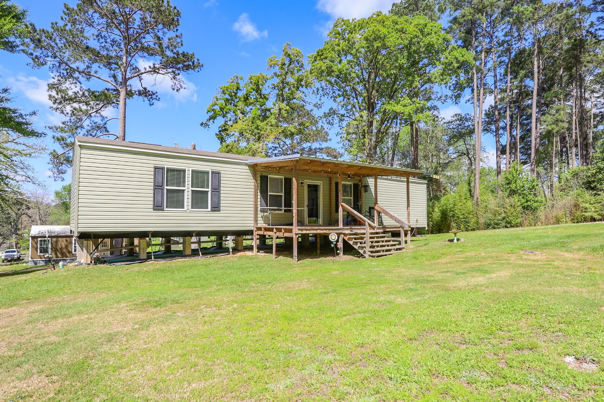 275 Bryan Street Zavalla, TX 75980 - Photo 3 of 24 a view of a house with a yard and sitting area