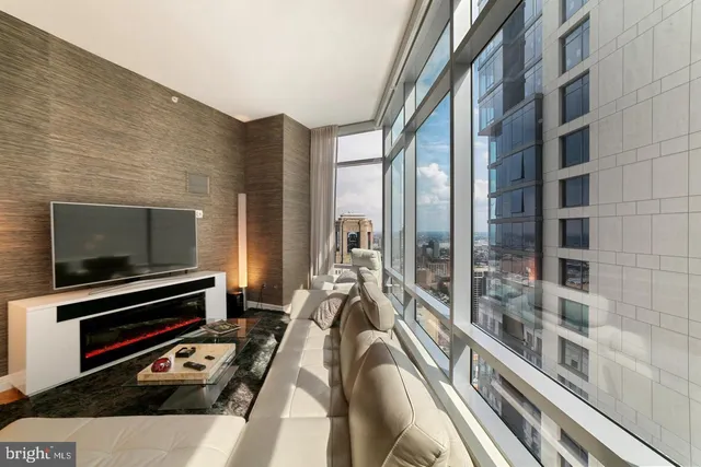a living room with furniture wooden floor and a flat screen tv