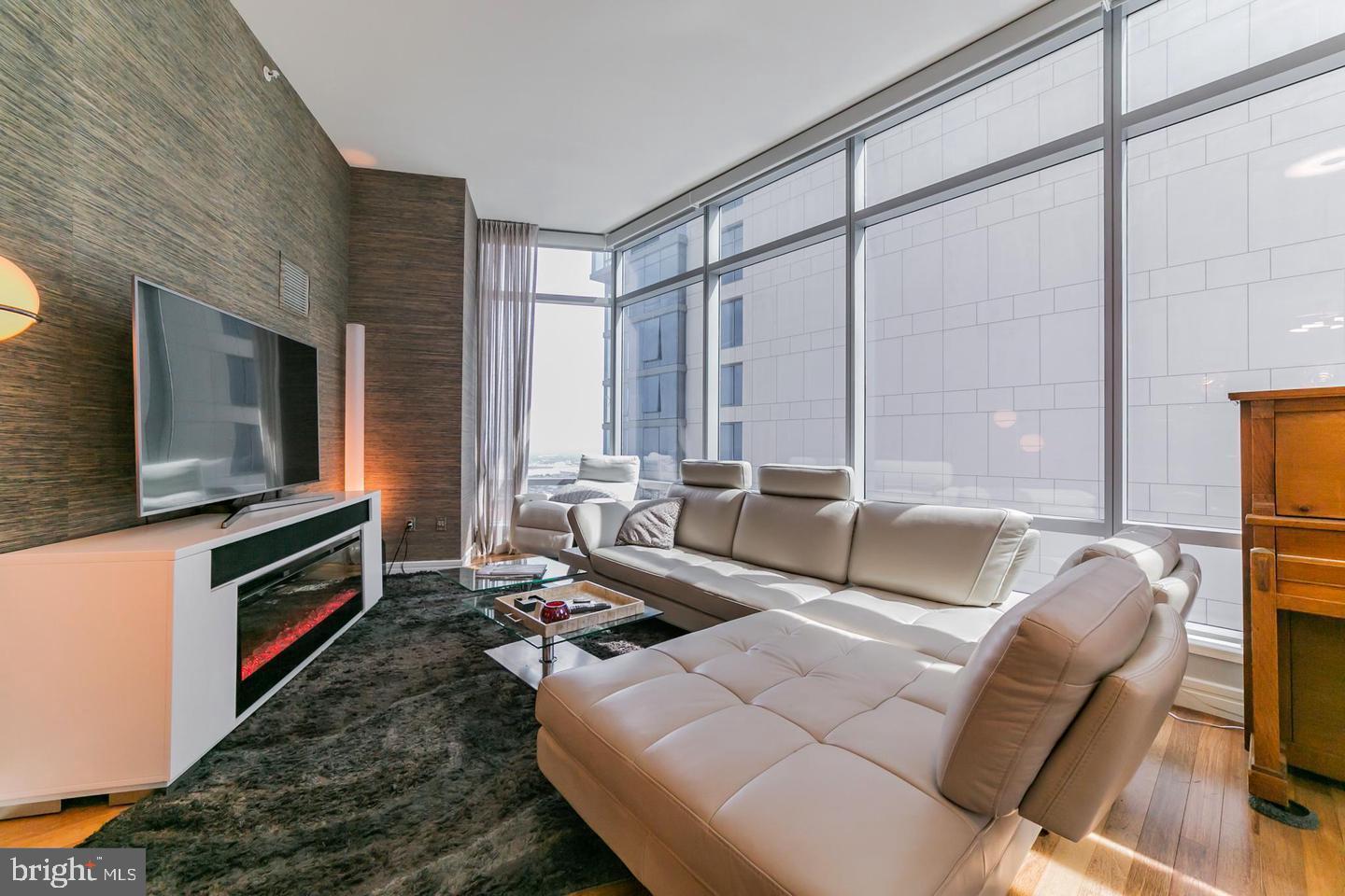 1414 South Penn Square, Unit 45A Philadelphia, PA 19102 - Photo 12 of 23 a living room with furniture wooden floor and a flat screen tv