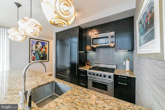 a living room with a couch a flat screen tv and a floor to ceiling window
