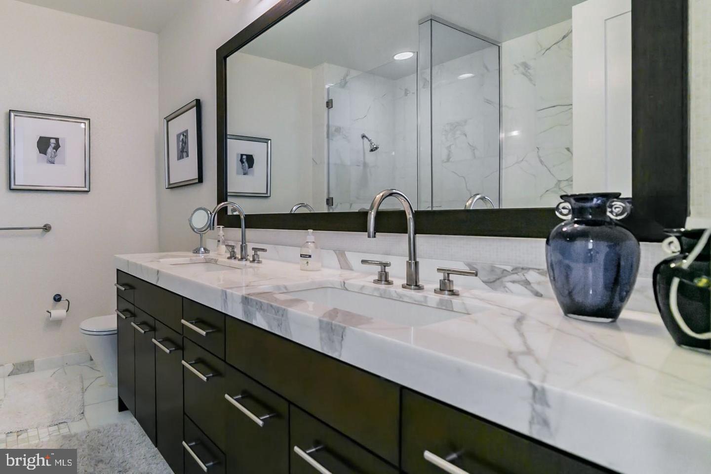 1414 South Penn Square, Unit 45A Philadelphia, PA 19102 - Photo 20 of 23 a bathroom with a double vanity sink a and a mirror
