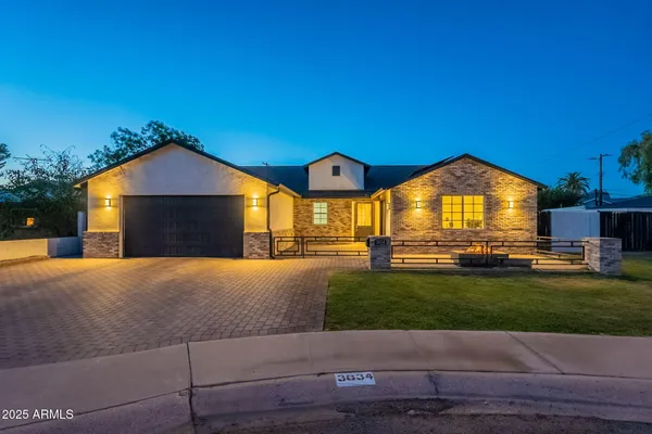 a view of a house with a yard and a garden