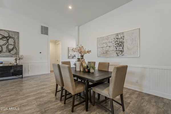 a kitchen with kitchen island a sink table and chairs
