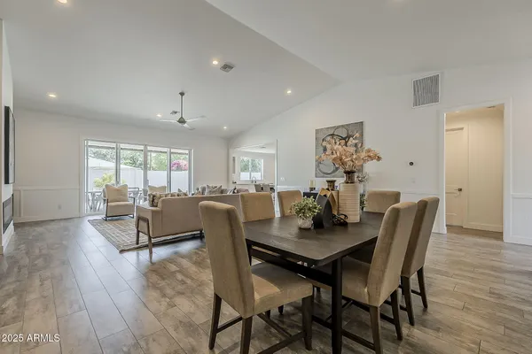 a kitchen with stainless steel appliances granite countertop a sink a stove and a refrigerator