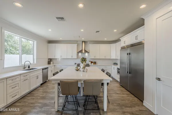 a white tub sitting next to a white sink