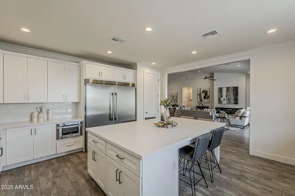 a view of a patio with a table and chairs and potted plants